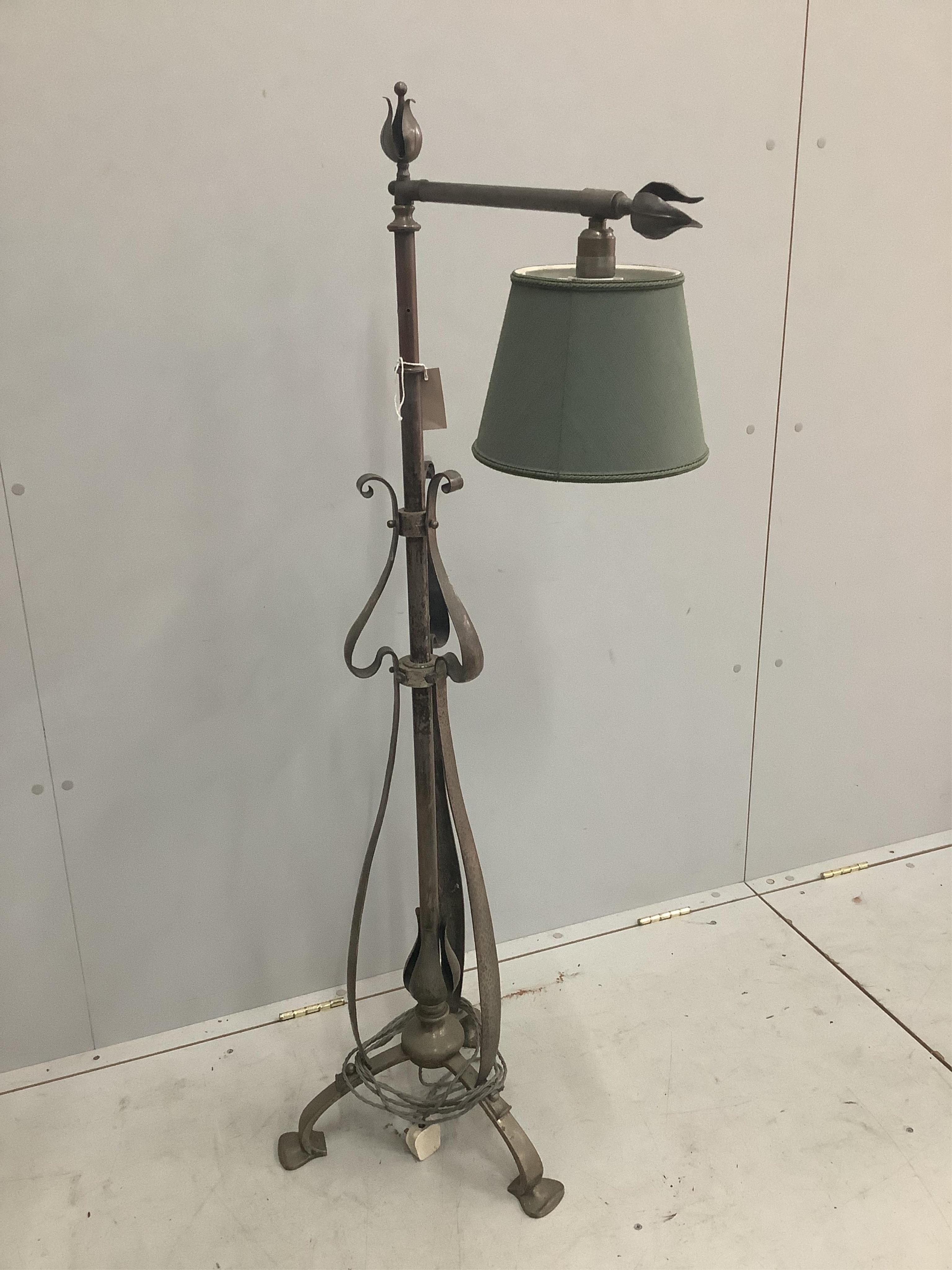 An Arts & Crafts wrought iron telescopic lamp standard. Condition - fair